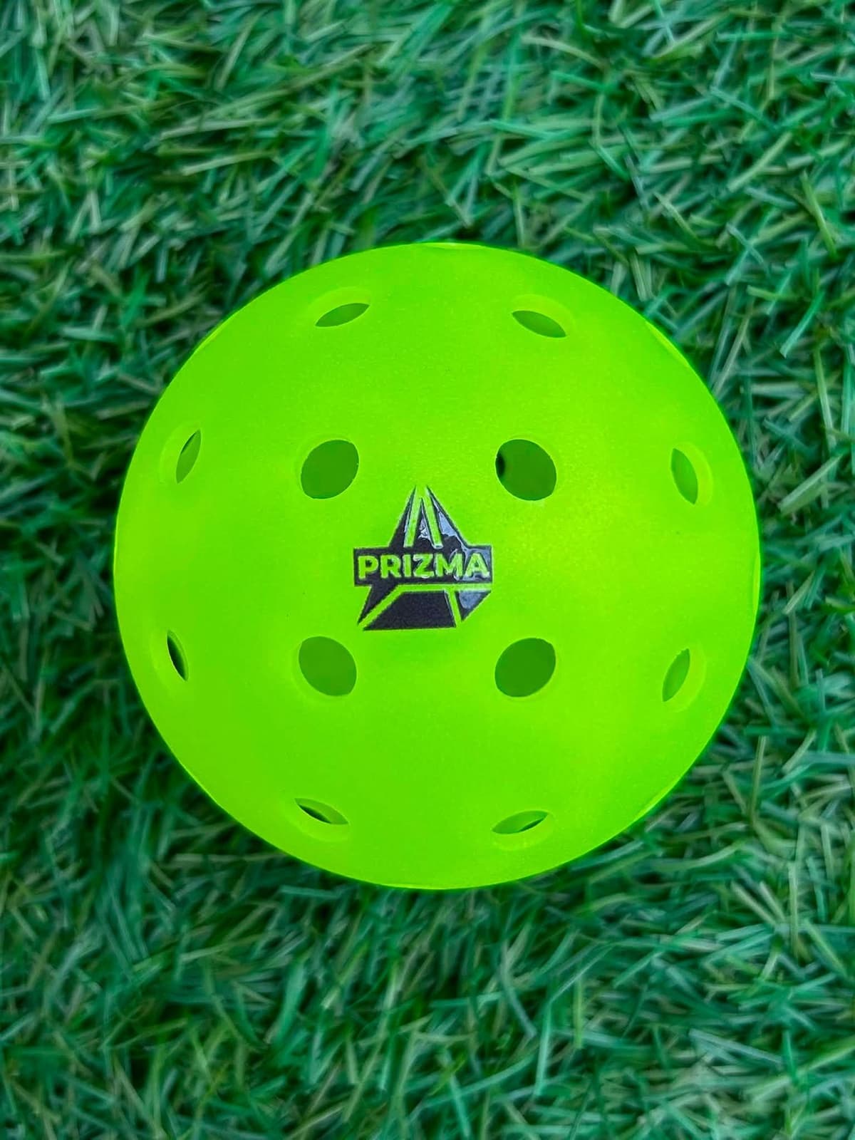 A single PRIZMA Ray 40-hole outdoor pickleball in optic yellow
